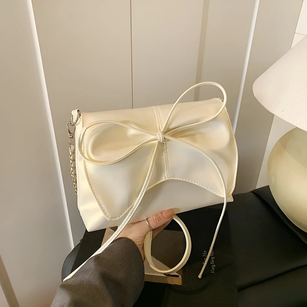Women's underarm crossbody bag in horizontal square shape with sewing line details and phone pocket