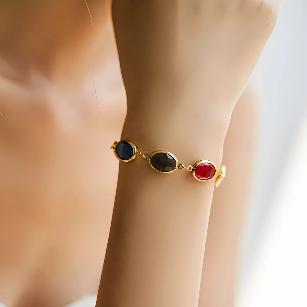 Geometric elliptical women's bracelet with blue glass inlay on an 18K copper band.