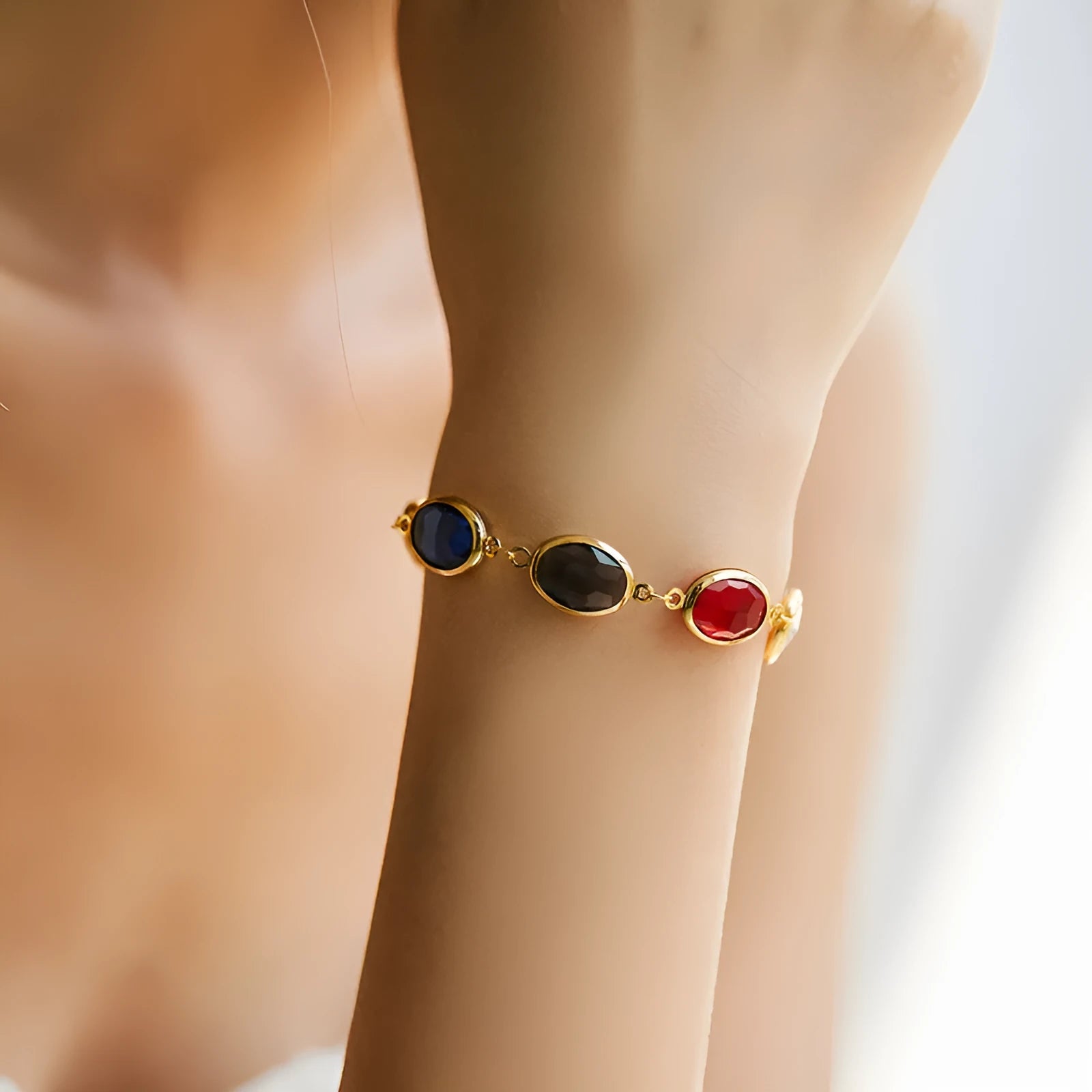Geometric elliptical women's bracelet with blue glass inlay on an 18K copper band.