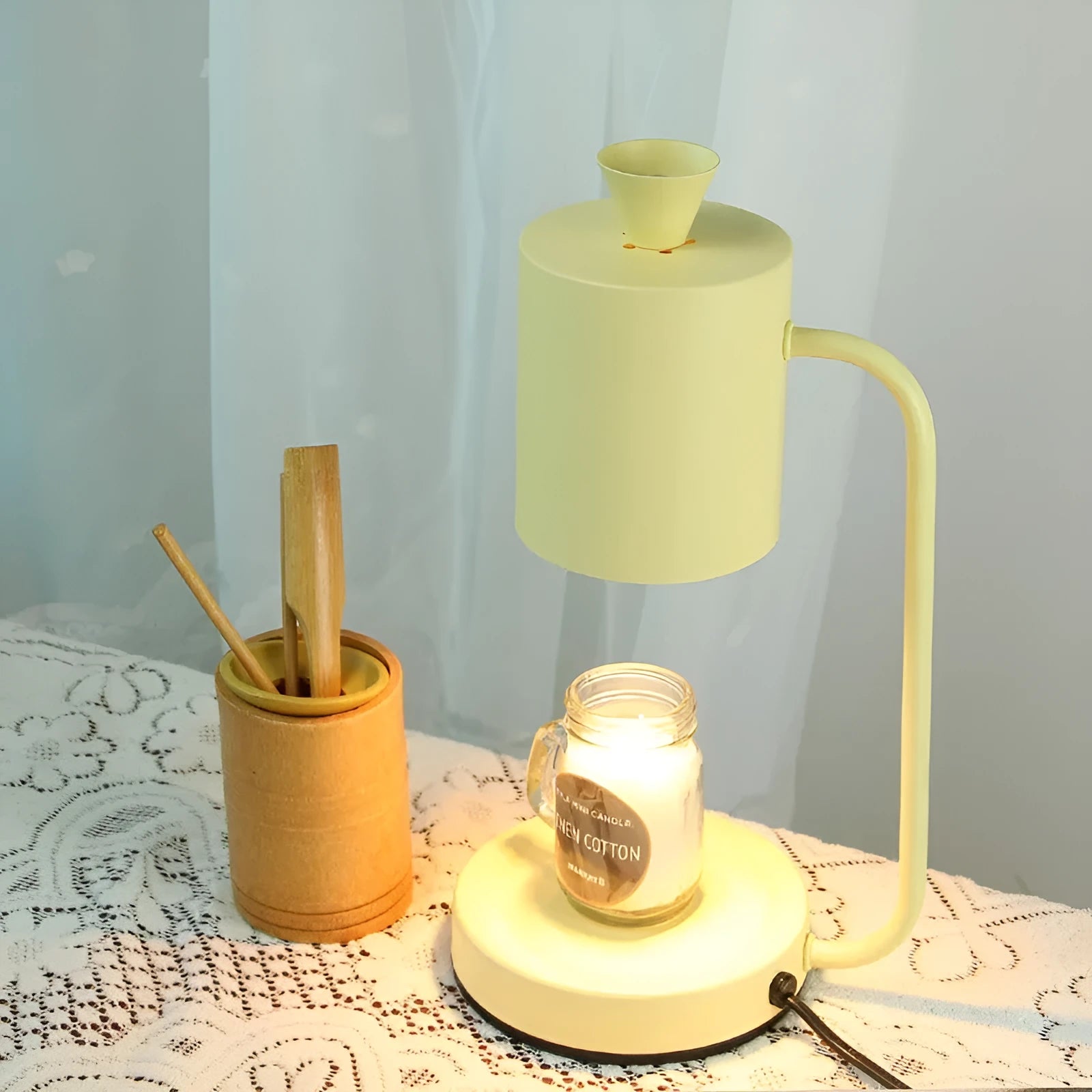 European-style white metal aromatherapy wax melting lamp with dimmer switch on table.