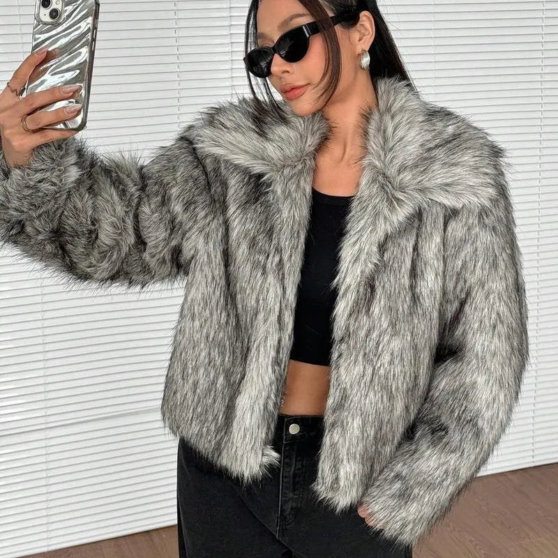 Women's short black artificial fur coat with a full fur collar and long sleeves.
