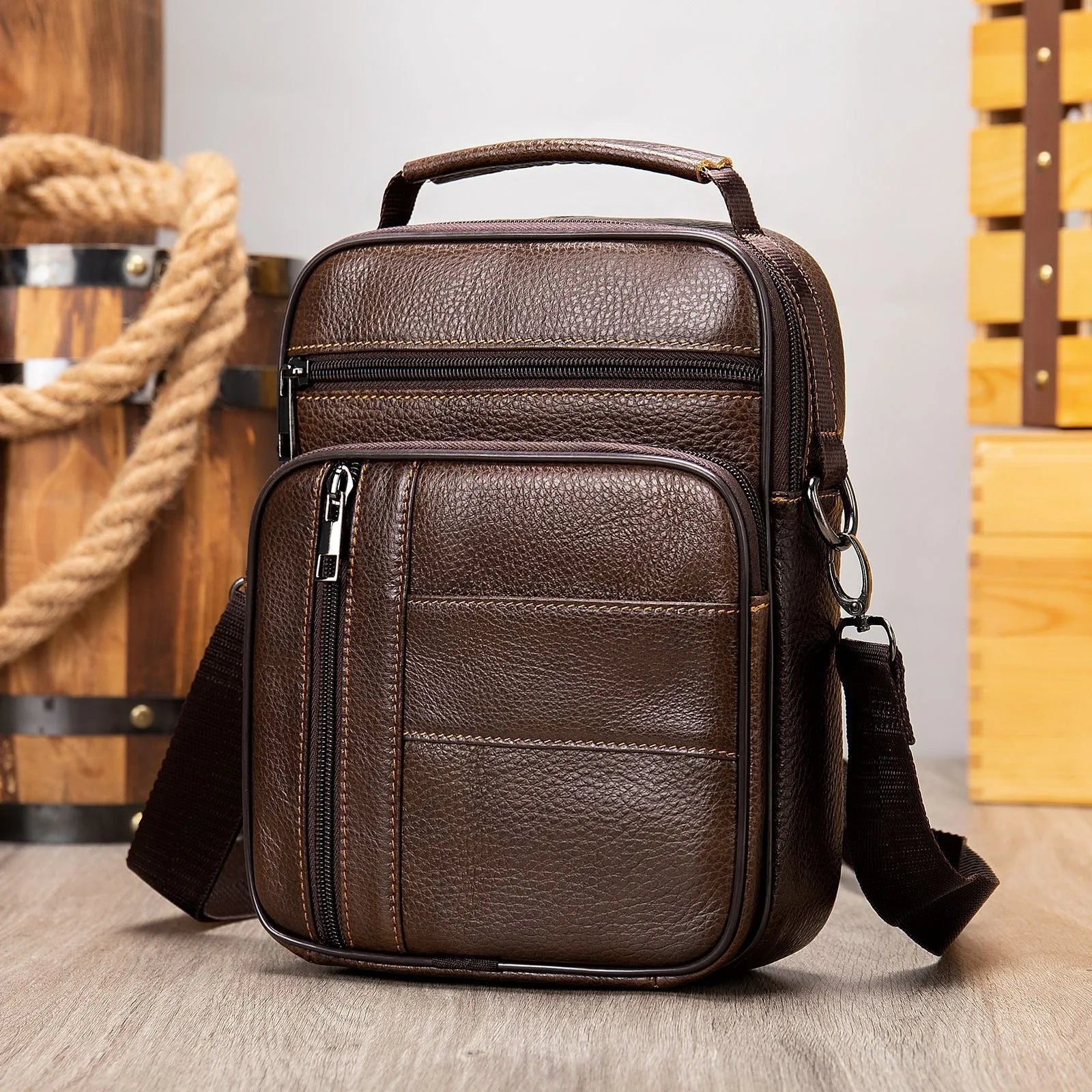 Men's black genuine leather vintage shoulder bag with a soft handle, shown closed.