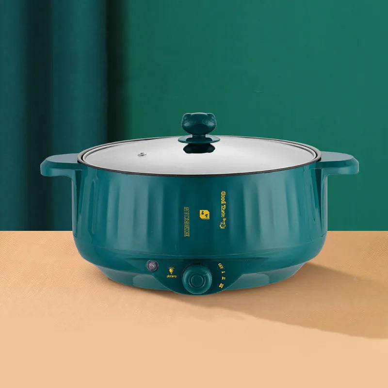White and green electric cooking pot with integrated heating element and non-stick stainless steel surface