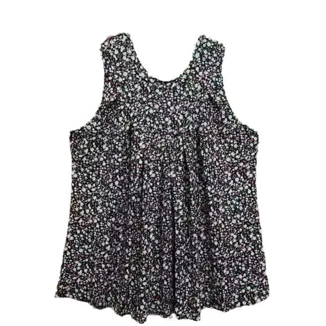 Plus size woman wearing a black floral printed sleeveless vest with a round neckline.