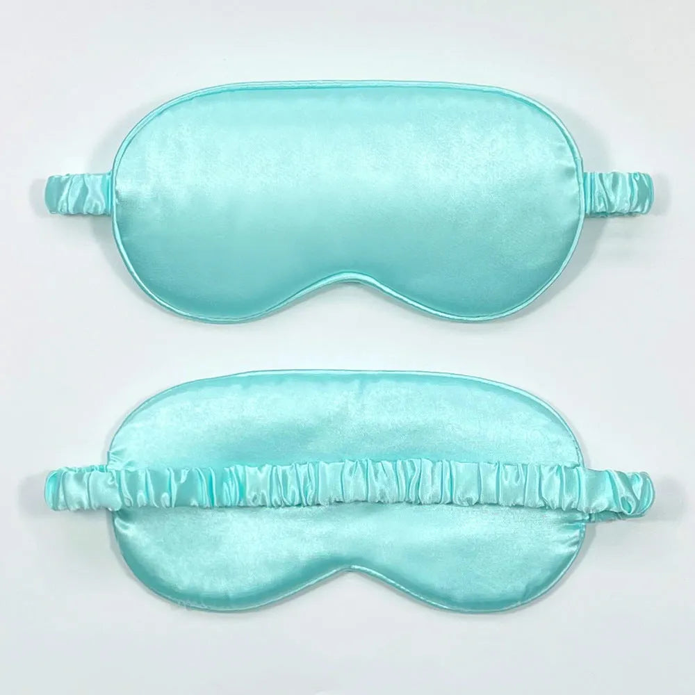 Reversible silk-like sleep eyeshade shown in multiple colour options including sky blue, wine red, and black.