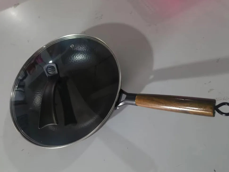 Traditional black iron wok with wooden handle showing 40cm diameter and flat induction base