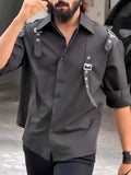 Men's black utility-style button-up shirt with a regular fit and button front.