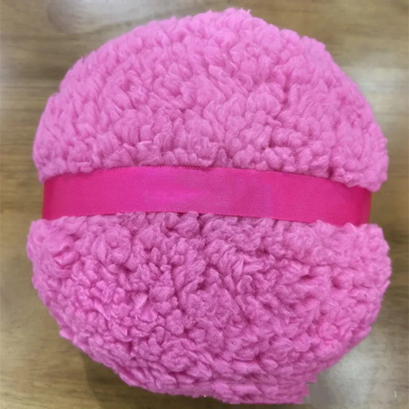 Oversized rectangular plush powder puff for makeup application in pink, white, or skin colour.