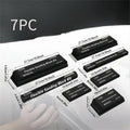 Set of seven identical black frosted metal building blocks for model making