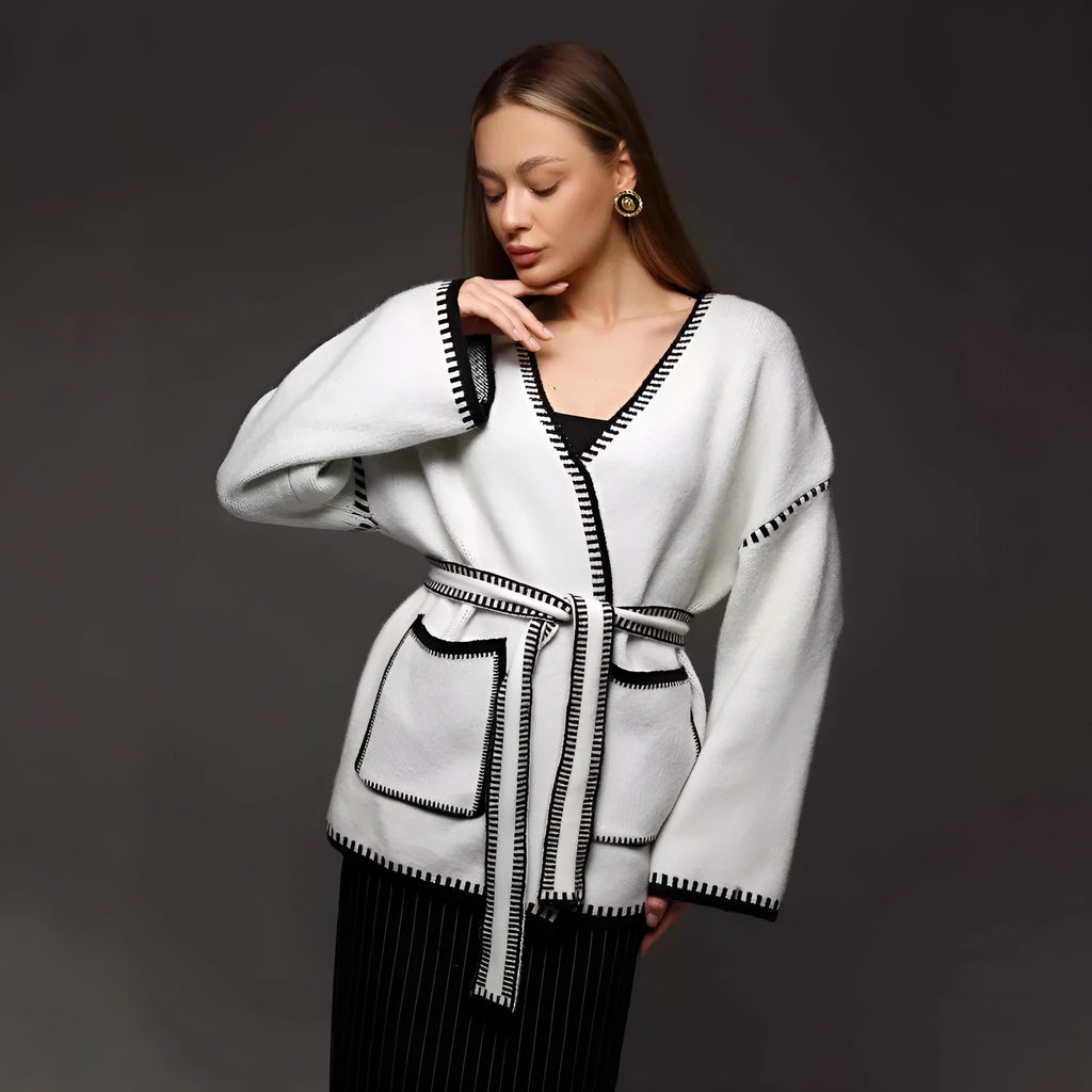Loose fit knitted cardigan sweater coat in camel colour, showing long sleeves and mid-length hem.