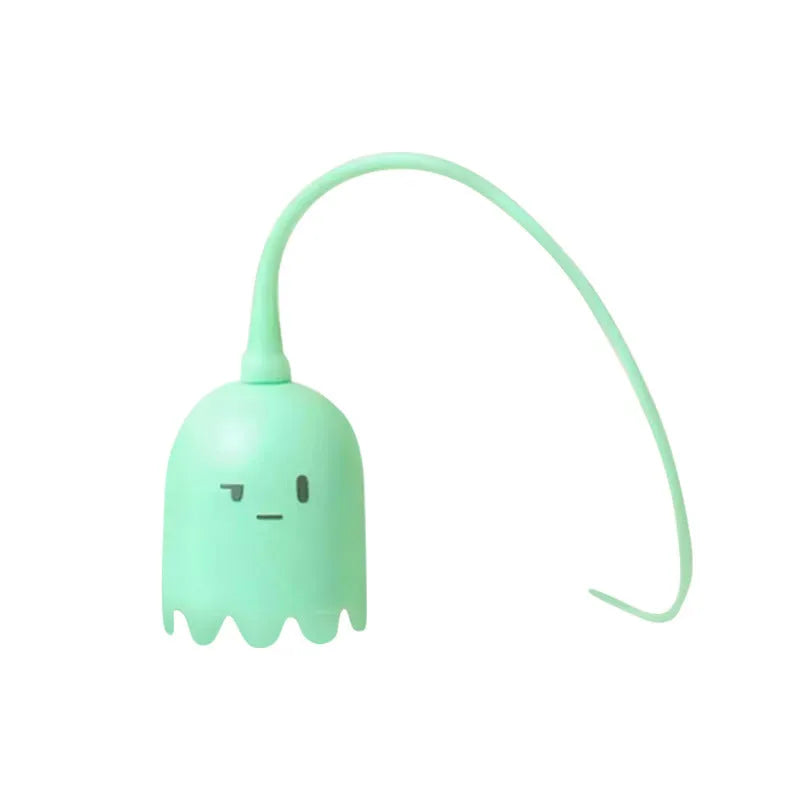 Green electronic cat toy with swinging silicone tail on floor for indoor cat play