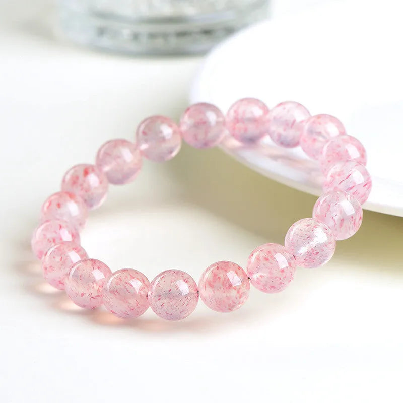 Natural white water strawberry quartz crystal bead bracelet with spherical 10mm beads on elastic.