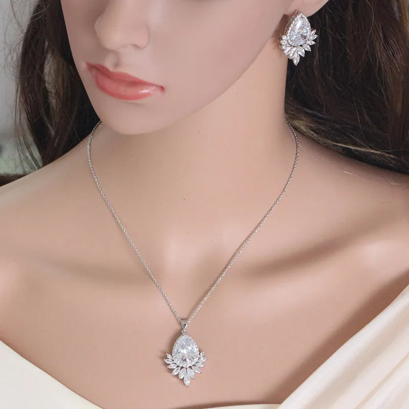 Silver-tone jewellery set with cubic zirconia stones including necklace, bracelet and earrings for formal events