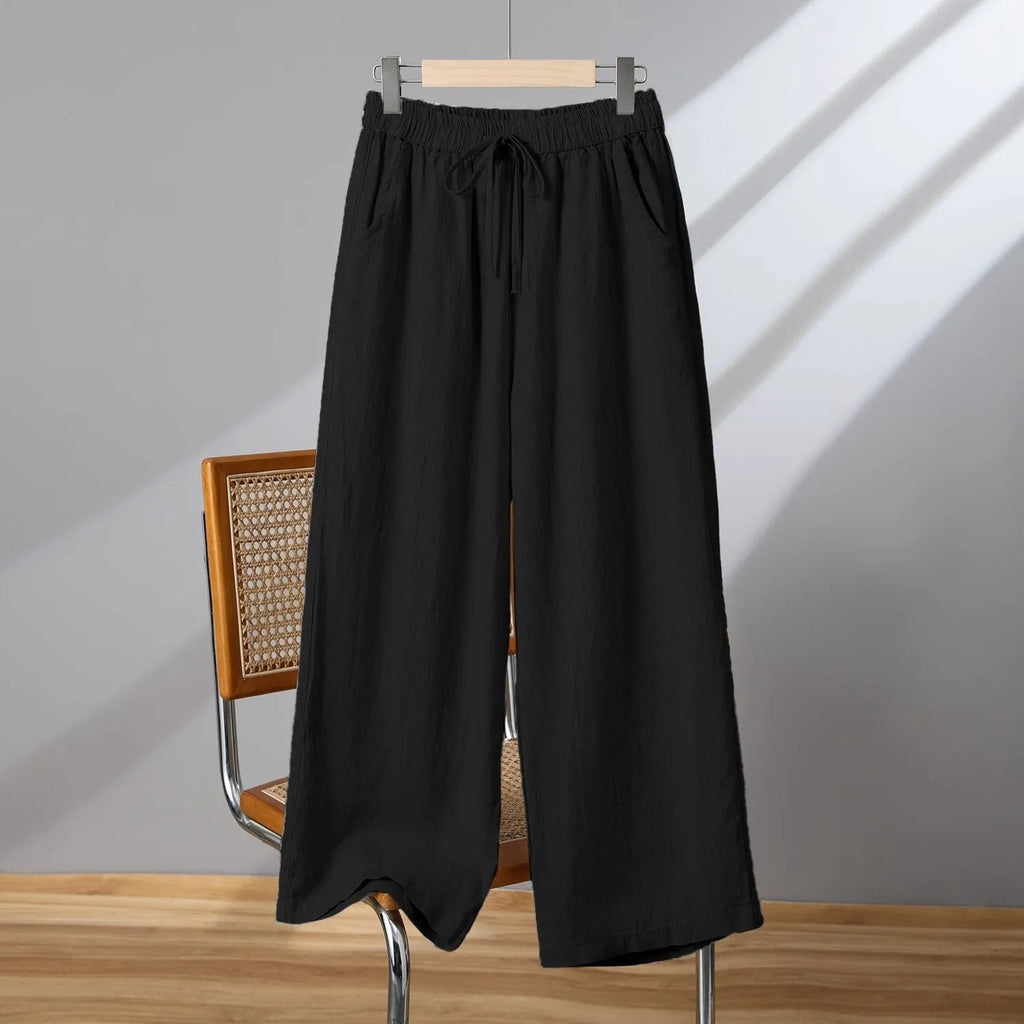 Women's straight leg casual trousers with elastic waist and lace-up drawstring detail in apricot colour.