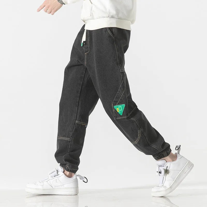 Men's loose-fit tapered cotton trousers in black colour showing mid-waist design and tapered leg cut