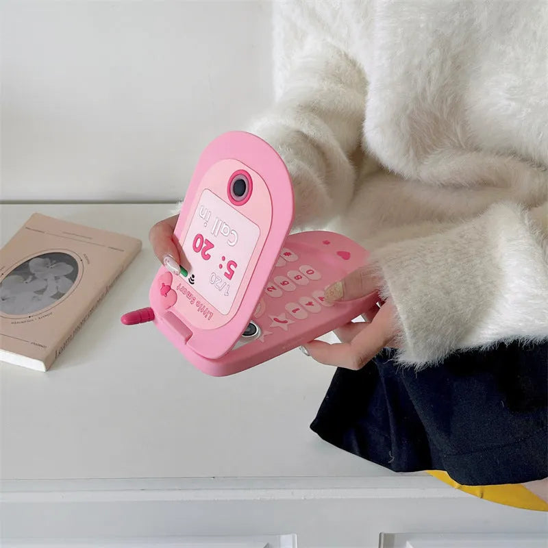 Pink silicone flip phone shaped iPhone case with built-in mirror for models 11 to 15