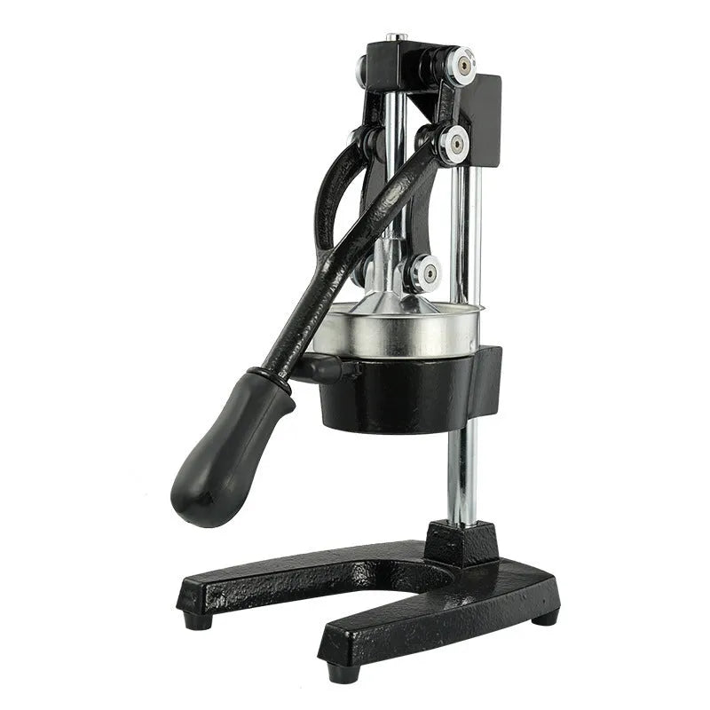 Black cast iron manual juicer with stainless steel strainer on kitchen counter