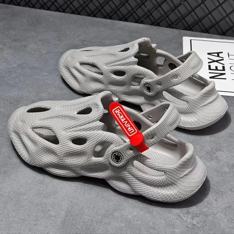 Men's grey coconut slippers with closed toe design and EVA construction on wooden deck