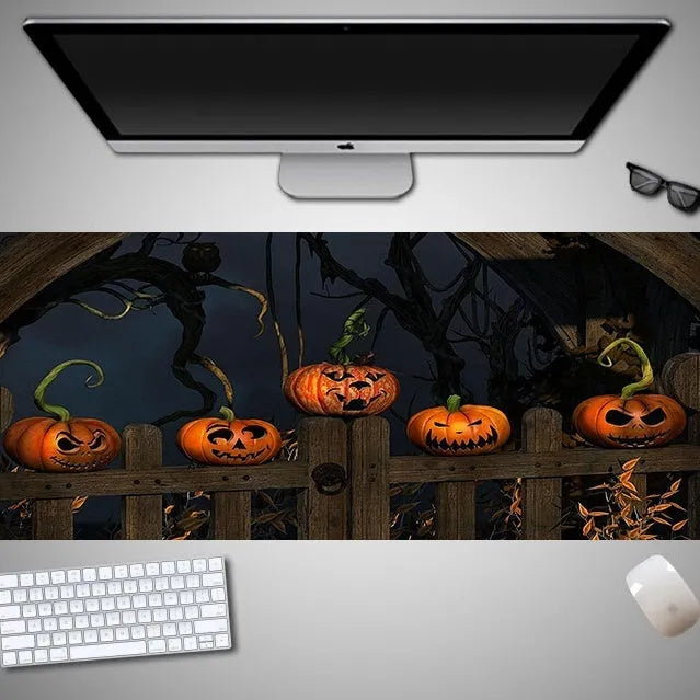 Oversized Halloween-themed computer mouse pad with non-slip rubber cloth base on a desk