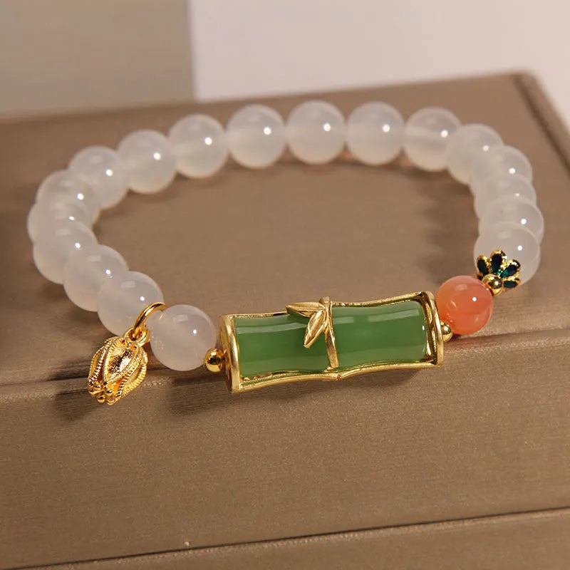 Women's white agate jasper bamboo bead bracelet with a single central jade focal bead.
