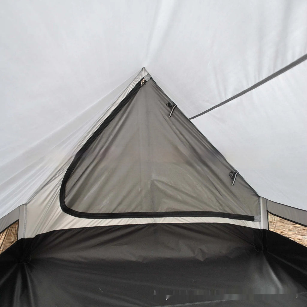 Brown A-line cabin tent pitched with hiking poles as structural support showing spacious interior for 2-3 people
