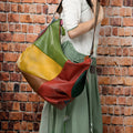Cowhide leather crossbody travel bag in picture colour, shown with shoulder strap