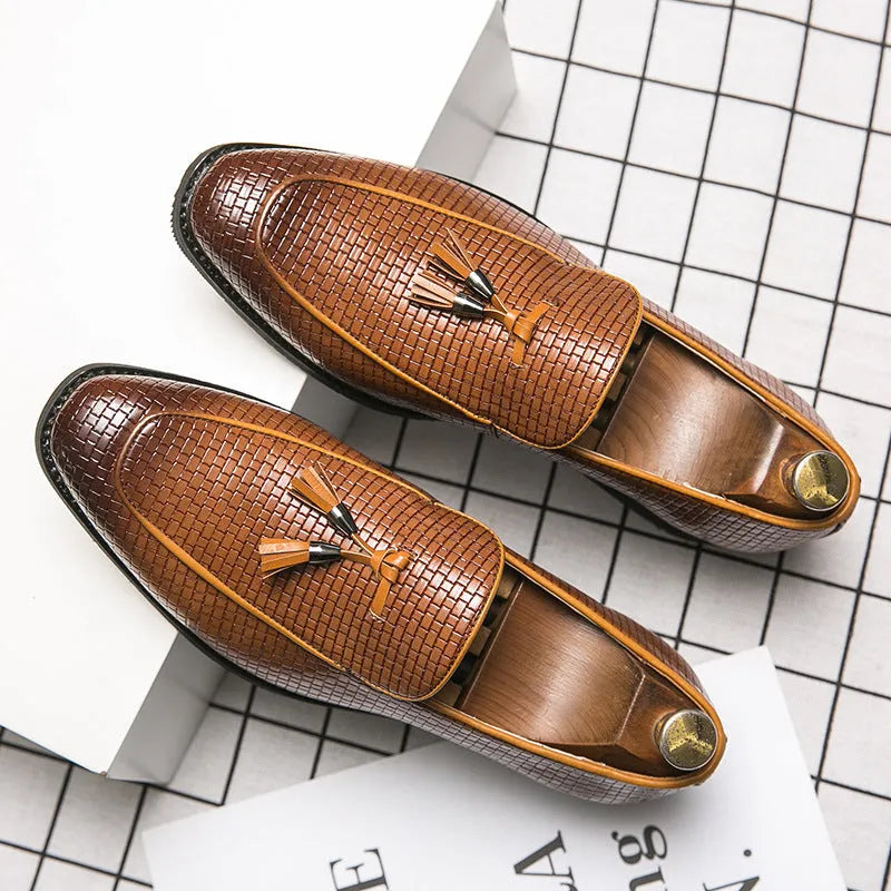 Men's black pointed toe slip-on shoes with a tassel detail on the vamp