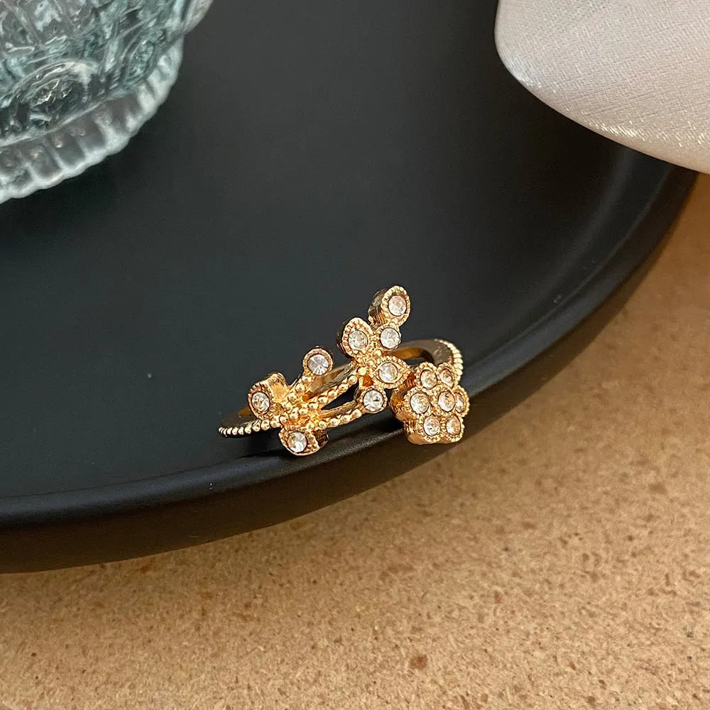 Women's copper floral open ring with diamond finish showing gold and white colour options