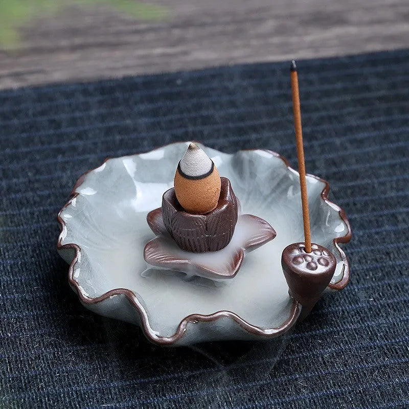Ceramic reverse flow incense burner in purple clay with crystal glaze featuring lotus or plum blossom design