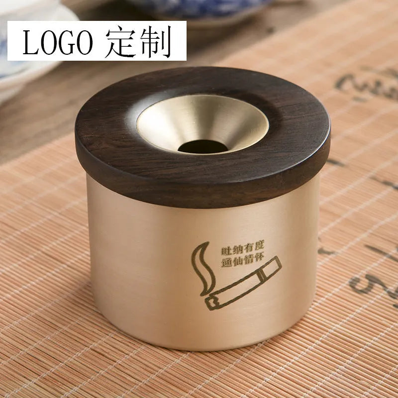 Brass ashtray with a wooden lid featuring a central hole, shown in black wood and red wood options.