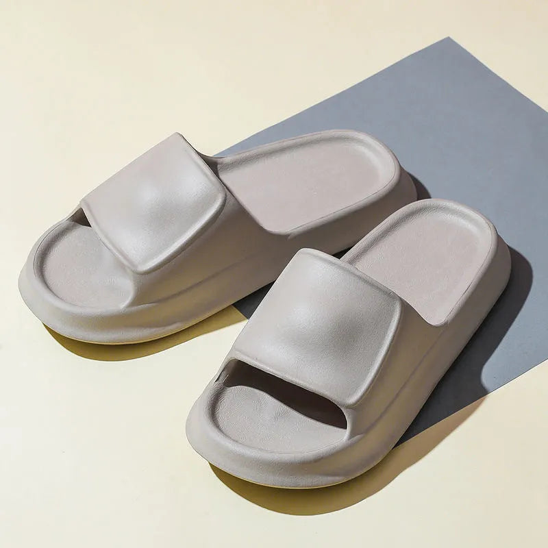 Thick-soled EVA flip-flop slippers in multiple colours on a bathroom floor, showing non-slip sole texture.