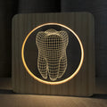 Tooth-shaped wood colour acrylic USB night light on a surface, showing its compact size.