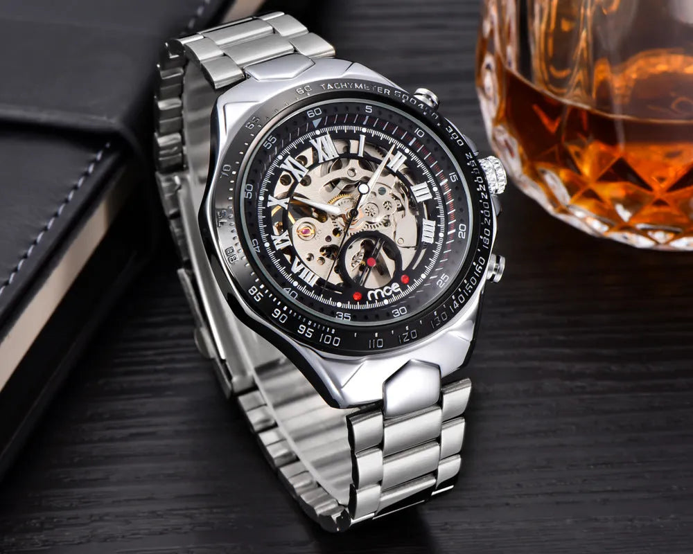 Men's mechanical watch with stainless steel case and brown leather strap showing luminous hands and date window