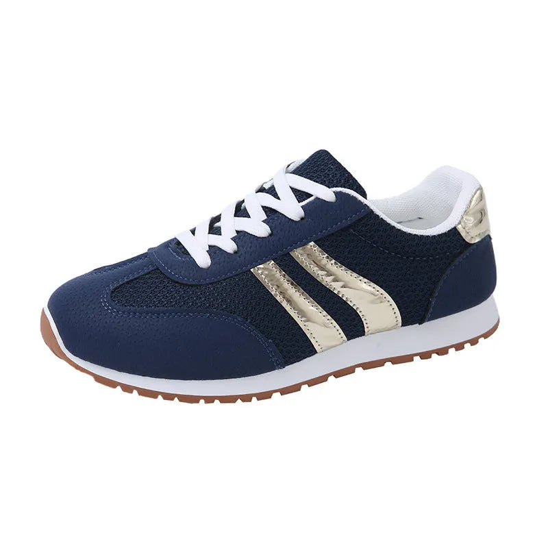 Blue women's casual sports shoes with lace-up front, cross shoulder straps, and a flat non-slip rubber sole.