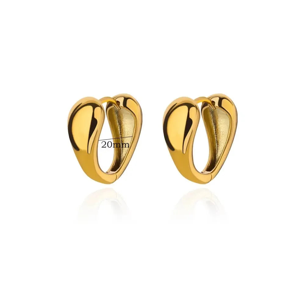 Geometric butterfly-shaped earrings with heart, bow, and star details in copper with a diamond-cut finish.
