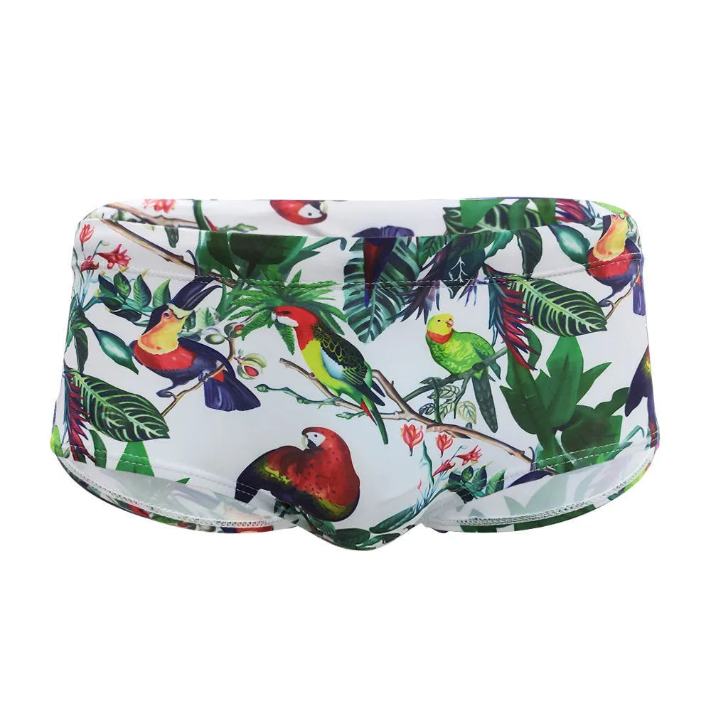Men's floral and bird print nylon swimming trunks in boxer brief style with cup cover.
