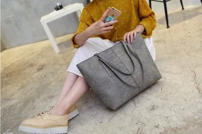 Minimalist European-inspired shoulder handbag in black or grey with adjustable strap