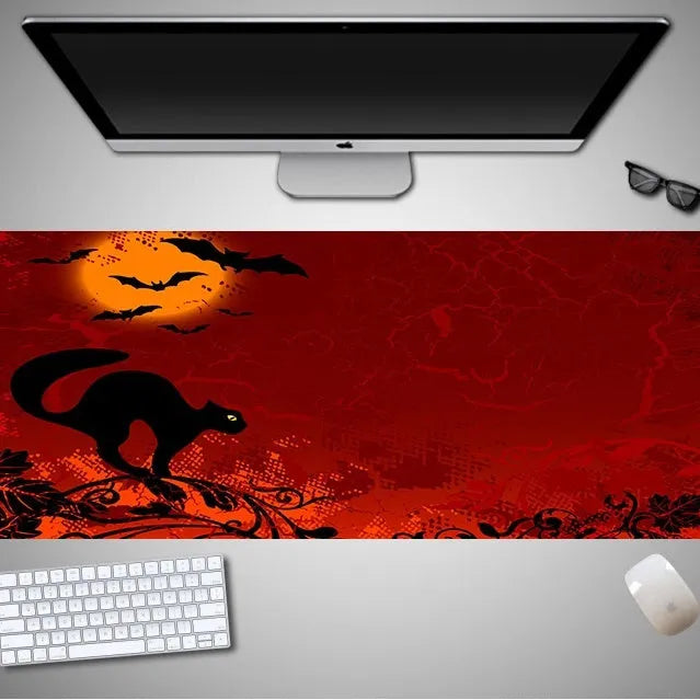 Oversized Halloween-themed computer mouse pad with non-slip rubber cloth base on a desk