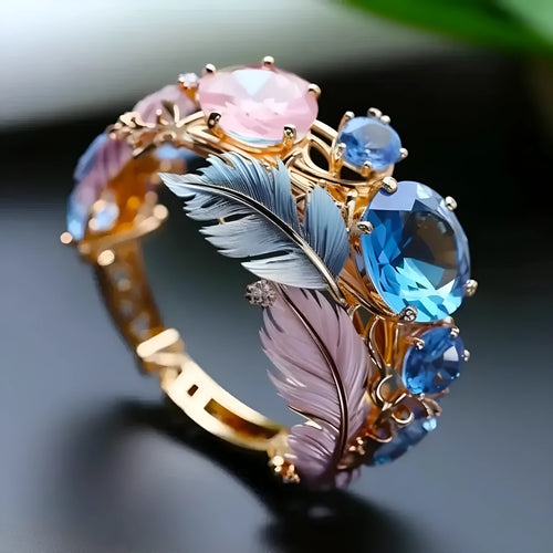 Gold brass ring with embossed feather design and zircon stone accents