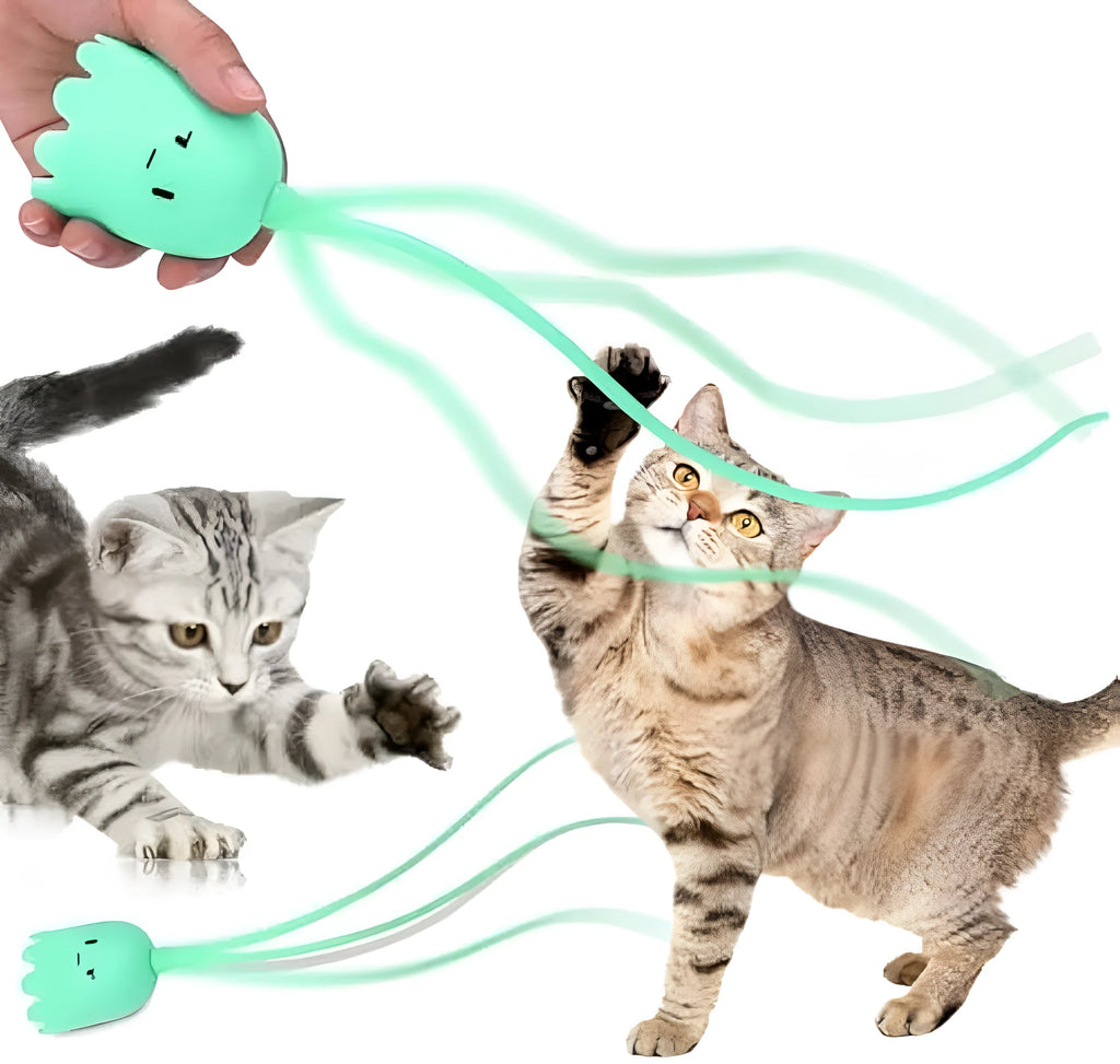 Green electronic cat toy with swinging silicone tail on floor for indoor cat play