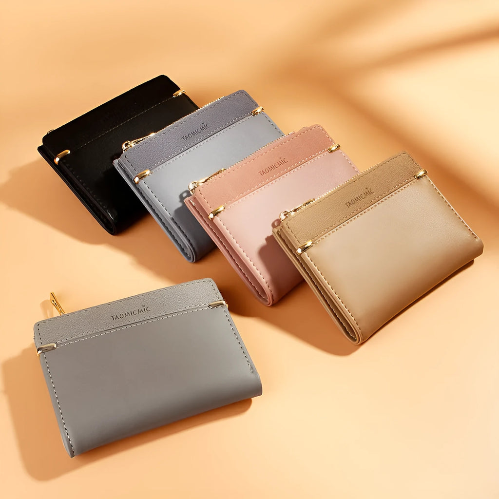 Black ladies folding wallet with a short zip, open to show multiple card slots, bill holder, and change compartment.