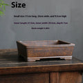 Rectangular purple sand bonsai pot with firewood burning texture on a floor.