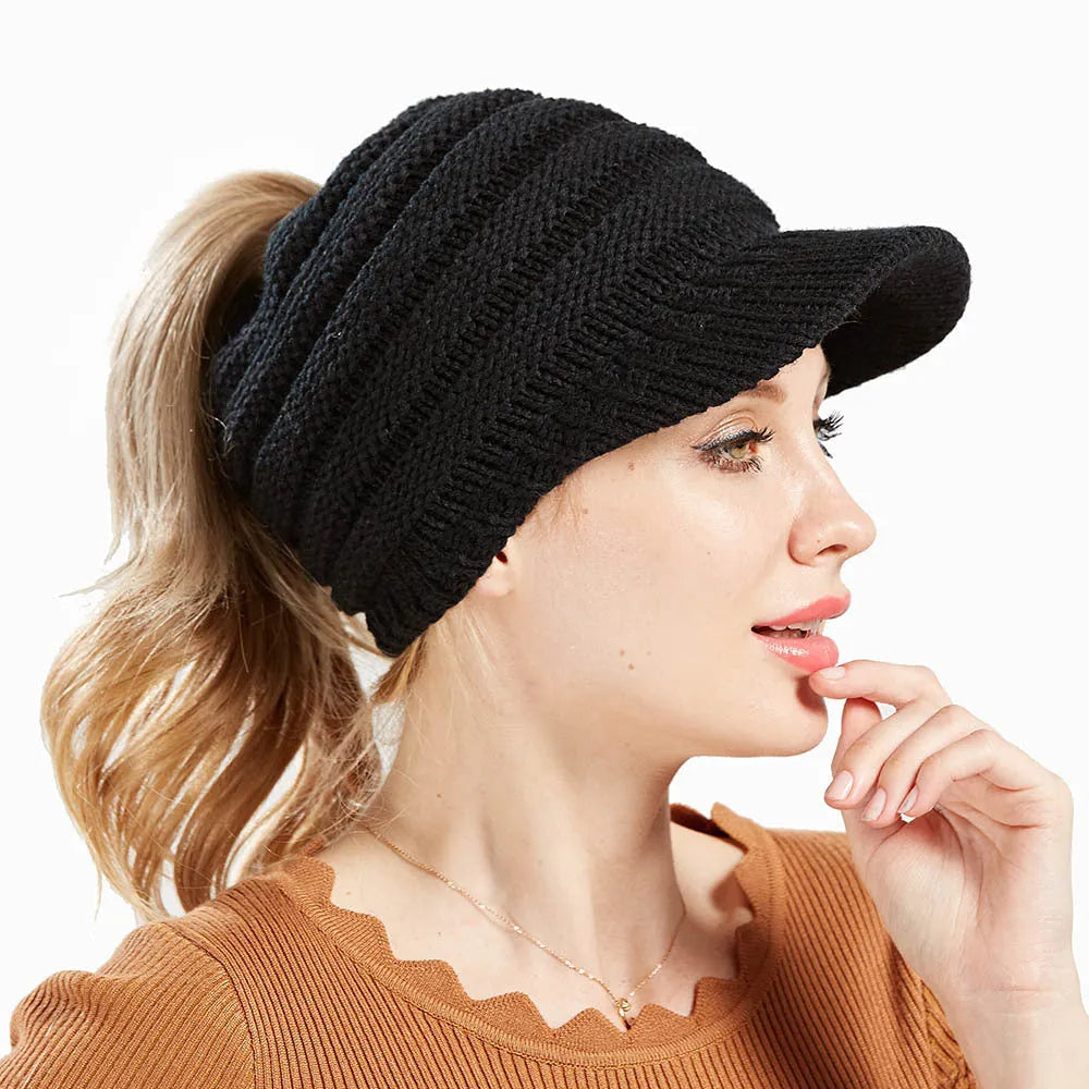 Women's knitted ponytail beanie with hair hole opening in acrylic yarn, shown in beige colour