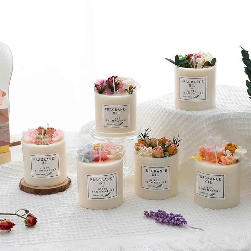 Aromatherapy candle decorated with dried flowers on top, shown in gift box packaging with a wood base.