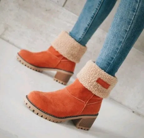 Women's black suede mid-tube knight snow boots with a thick sole and low flat heel on a plain background.