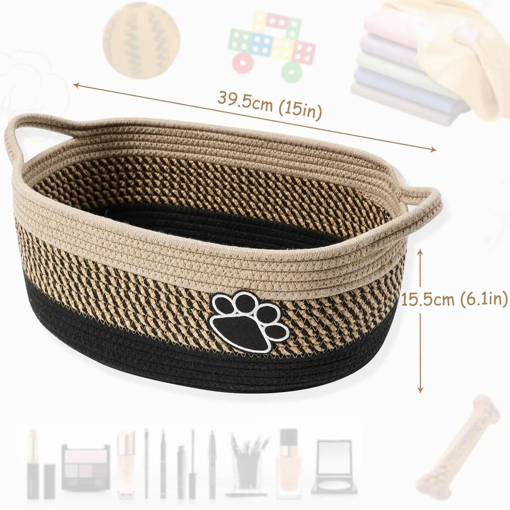 Light beige handmade cotton rope storage basket with wooden handle on a table.