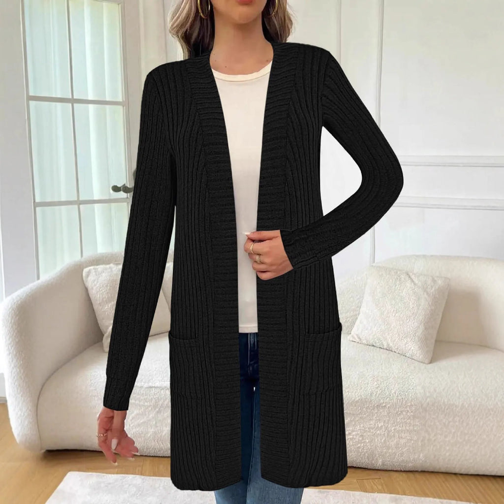 Long sleeve loose fit knitted cardigan jacket in black, shown with two front pockets.
