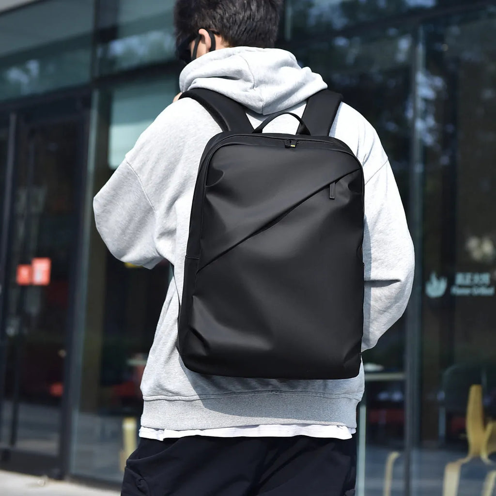 Waterproof black PU leather backpack with sewing thread details and large capacity storage