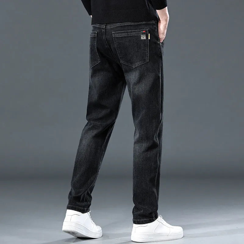 Blue grey and black slim straight loose casual thin trousers on a hanger, showing mid waist and zipper fly.