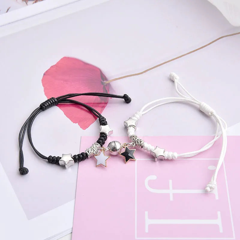 Pair of alloy suction bracelets with engraved symbol choices including crown, love lock, and clover.